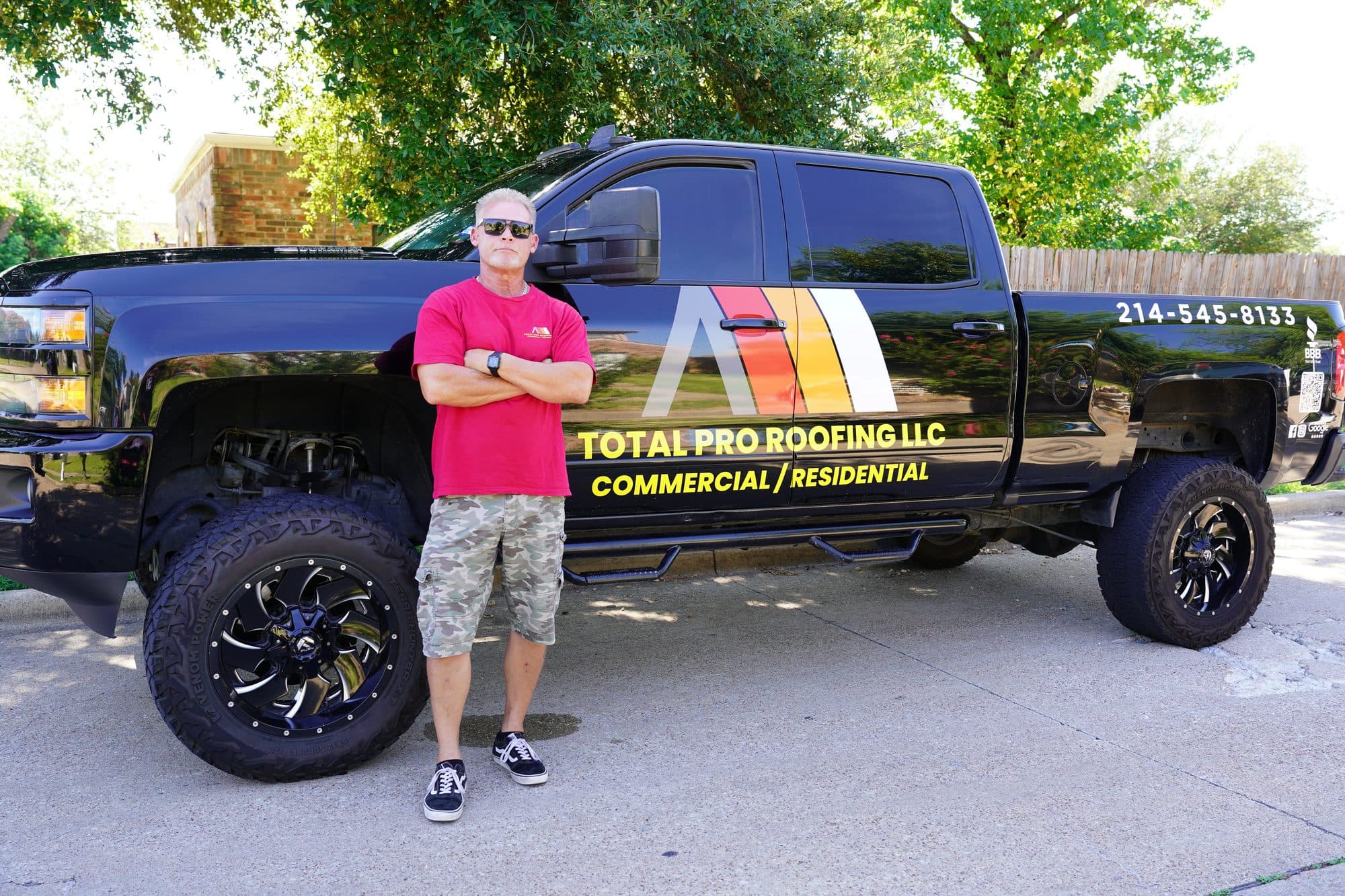 Duane Huddleston beside the Total Pro Roofing truck