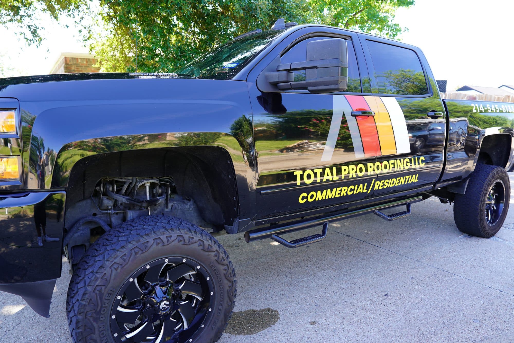 Total Pro Roofing LLC work truck with the company logo